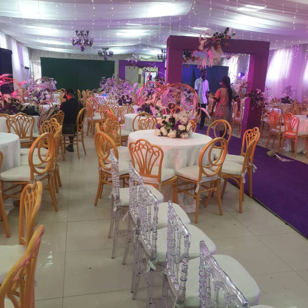 Floral centrepieces and purple decorative arches at the event centre